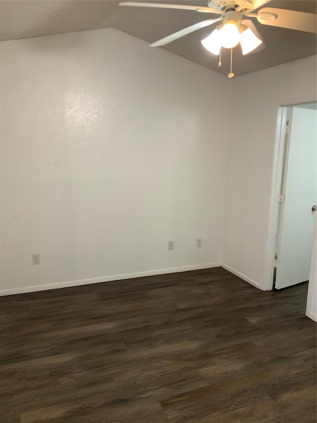 Unfurnished room featuring baseboards, ceiling fan