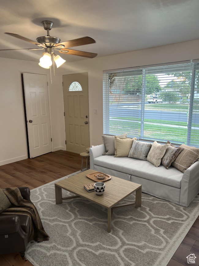 Living room with wood finished floors and ceiling fan
