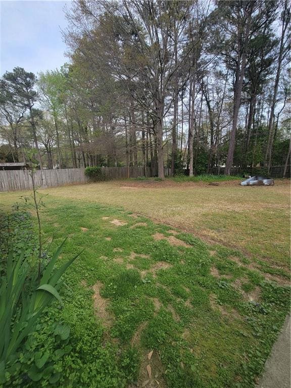View of yard featuring fence and an outdoor structure