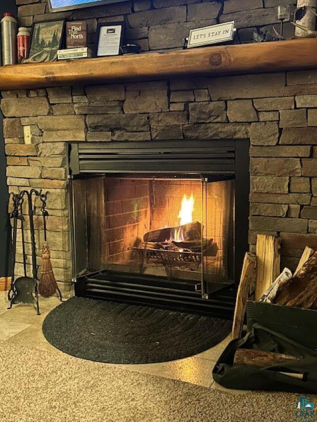 Interior details featuring a fireplace and carpet floors
