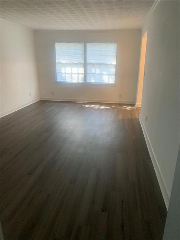 Family room view from the kitchen featuring dark hardwood / wood-style floors