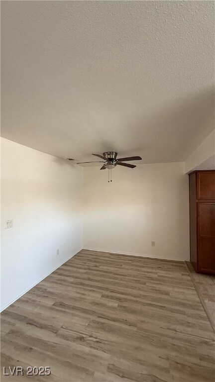 Spare room with ceiling fan, light wood-style floo
