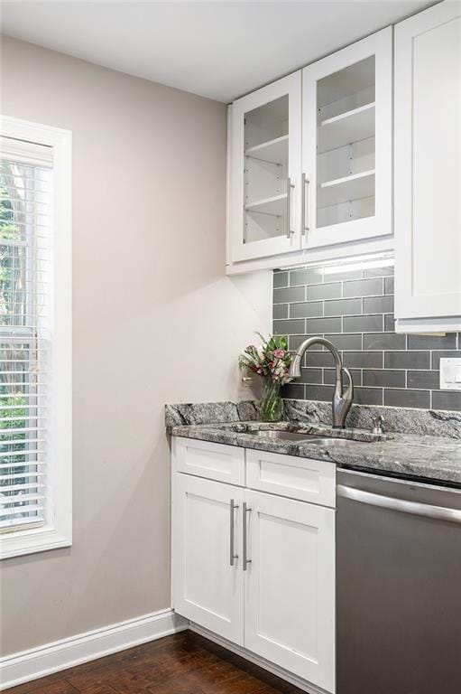 Bar featuring stainless steel dishwasher, a sink, 