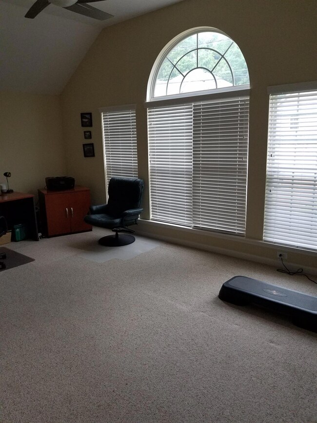 Amazing Upstairs Bonus Room has lots of natural light from a wall of beautiful windows.