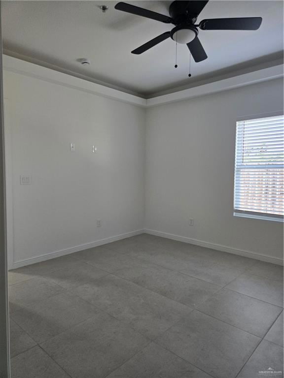 Spare room with baseboards, ceiling fan, and tile patterned flooring