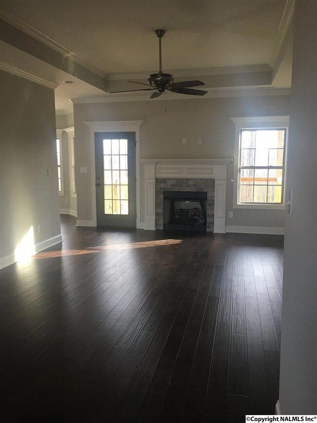 Great room, hardwoods, trey ceiling and beautiful view of wooded lot