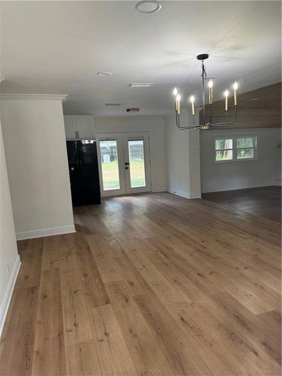 Unfurnished room featuring an inviting chandelier,
