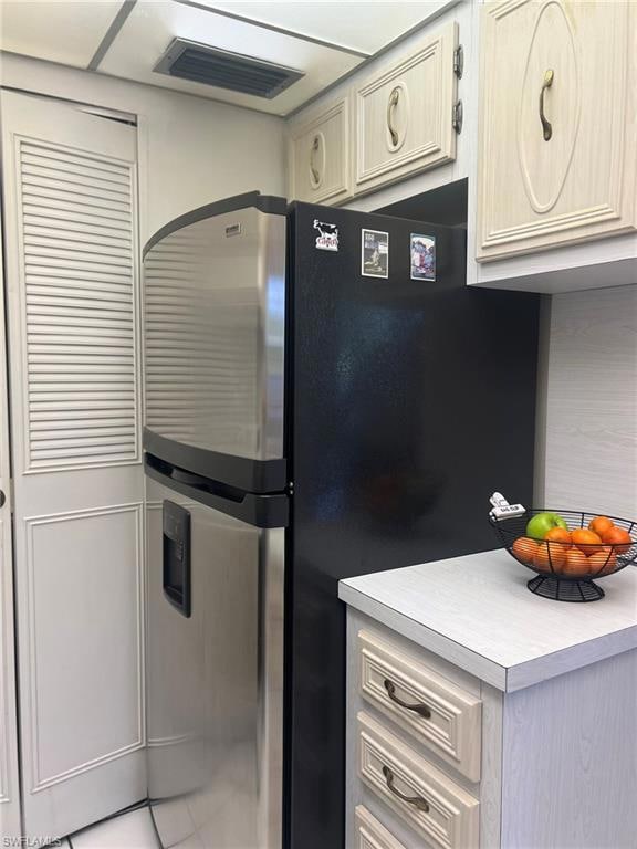 Kitchen with tile patterned flooring and stainless