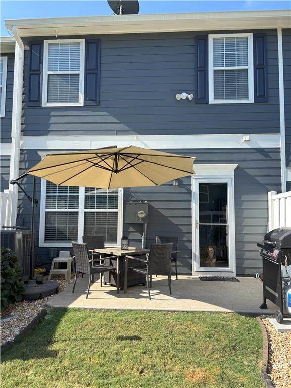 Back of property with a patio area and a yard