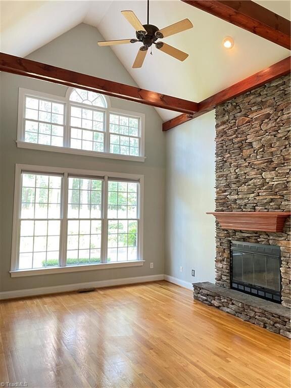 Impressive vaulted ceilings with exposed beams and stone fireplace