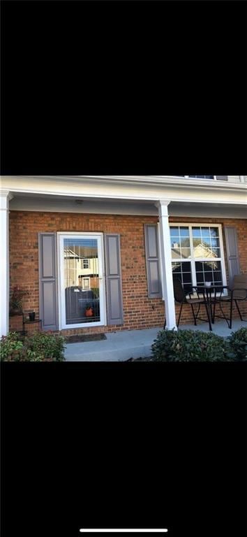 Property entrance featuring brick siding