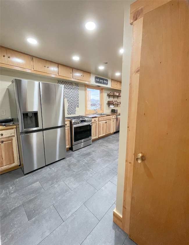 Kitchen featuring stainless steel appliances, recessed lighting, and light brown cabinets