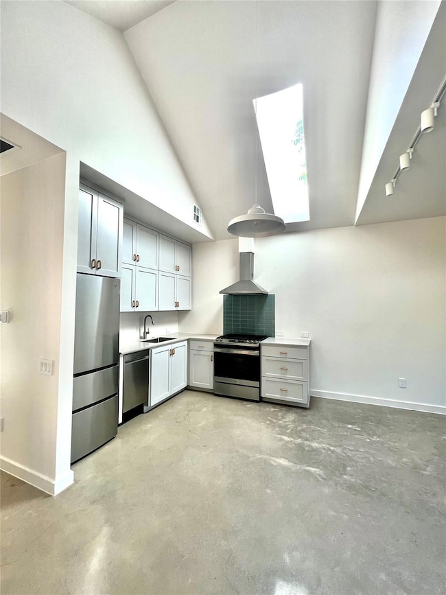 Kitchen featuring stainless steel appliances, wal