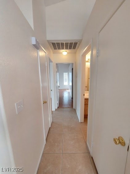 Corridor featuring light tile patterned floors and