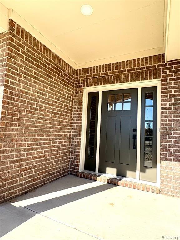 View of exterior entry, duel sidelights and steel door