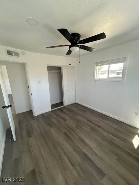 Unfurnished bedroom with dark wood-style flooring,