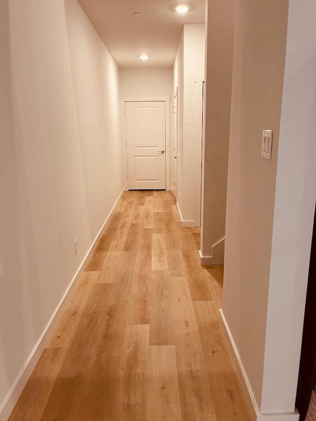 Hall featuring light wood finished floors