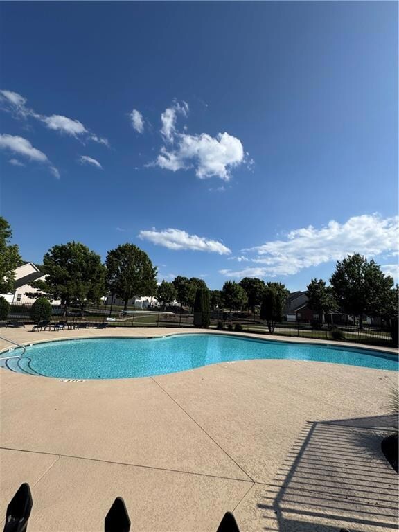 Community pool featuring a patio area