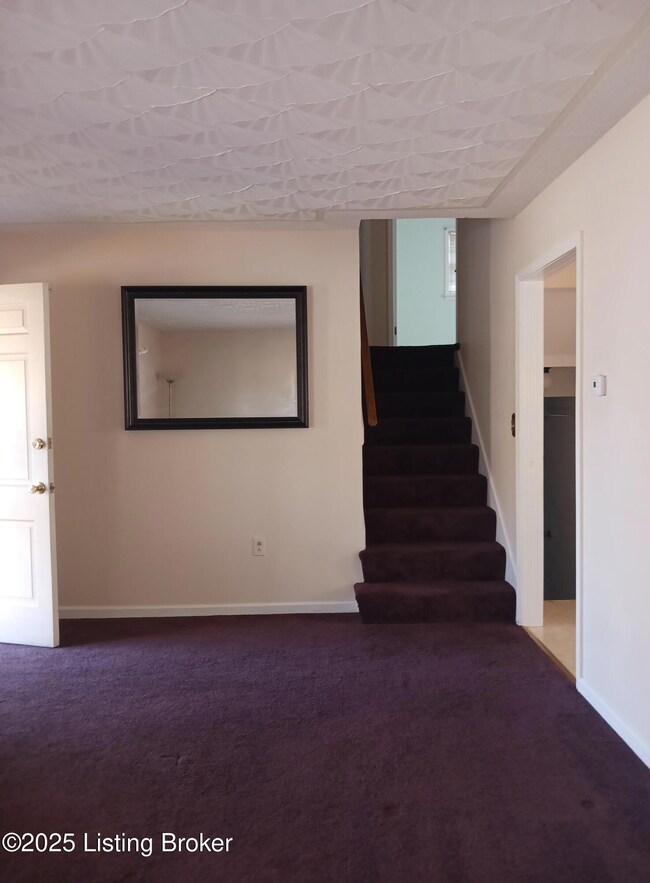 Living room with stairs to second level