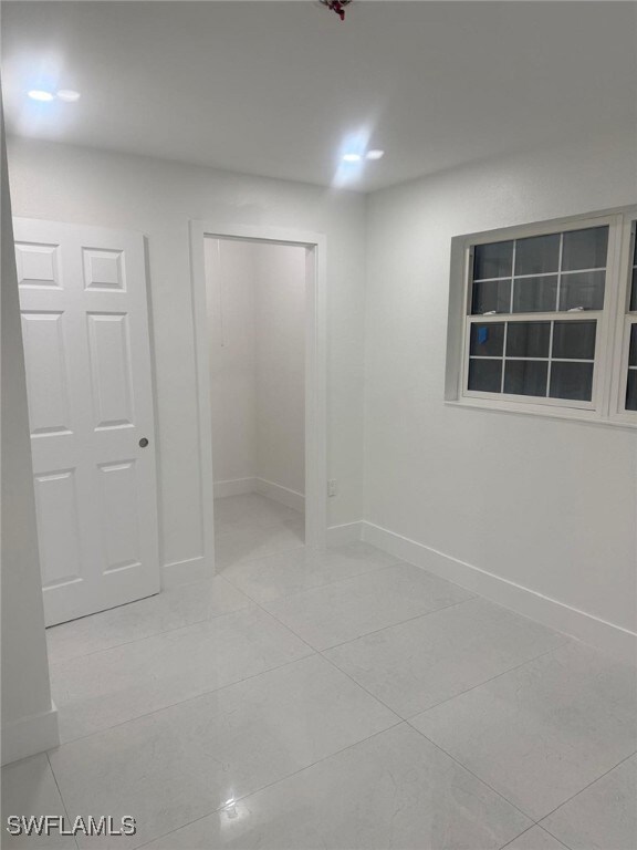 Spare room with light tile patterned flooring