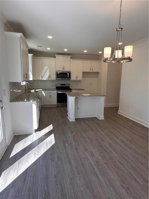 Kitchen with 5 burner stove and stainless applianc