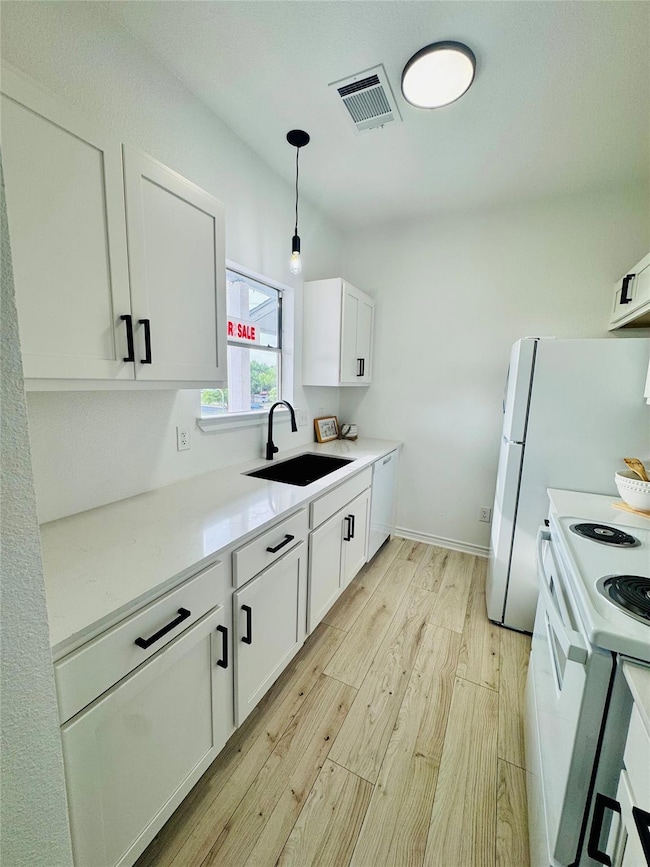 Kitchen featuring visible vents, light wood-style