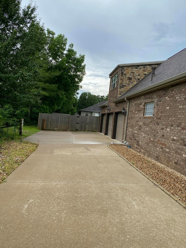 Up driveway toward 3-car garage