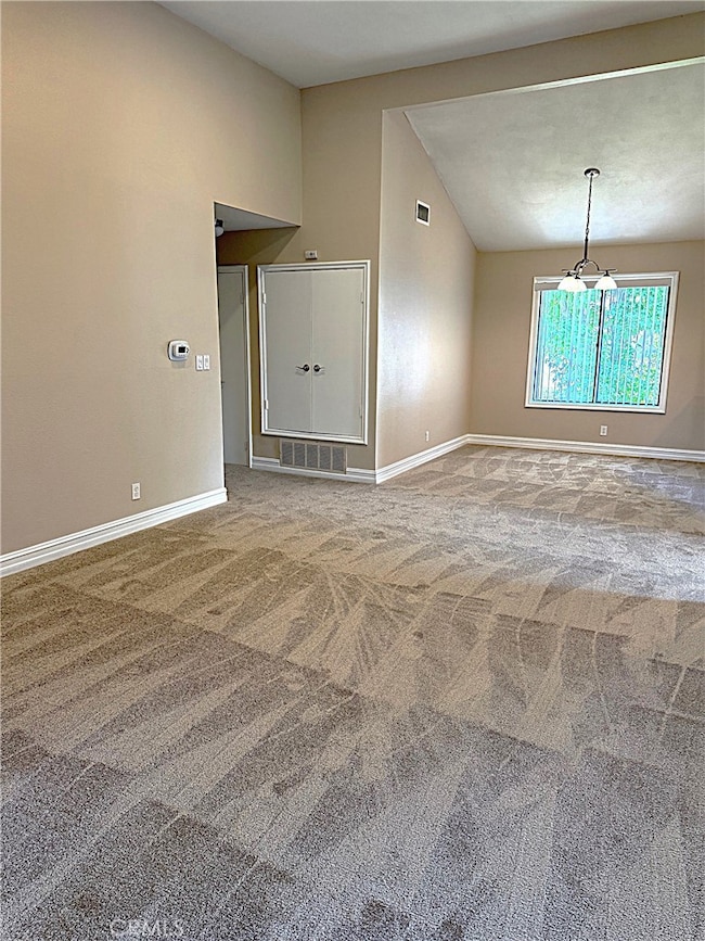 Living room looking towards the dining room and hallway to the primary bedroom.
