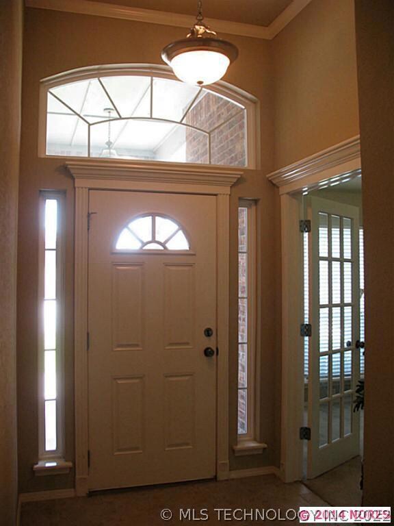 Entry with high ceiling and decorative window trim