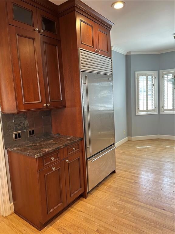 Kitchen with light wood finished floors, baseboard