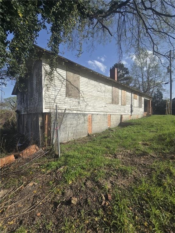 View of side of home with a chimney