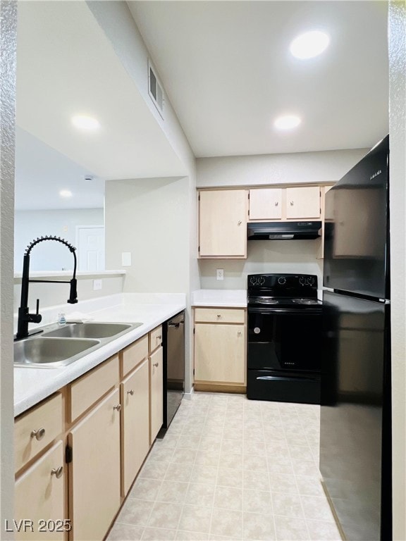 Kitchen with a sink, visible vents, light countert