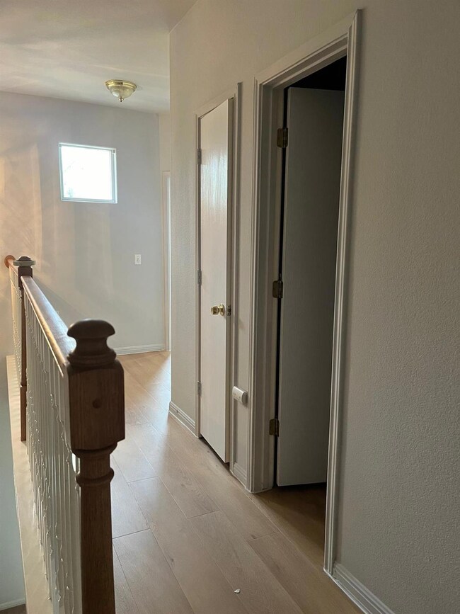 Corridor featuring light wood finished floors, an