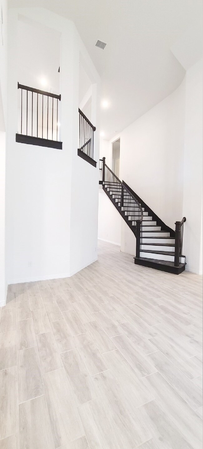 Beautiful, curved stairs to be viewed by you and guest from the family room.