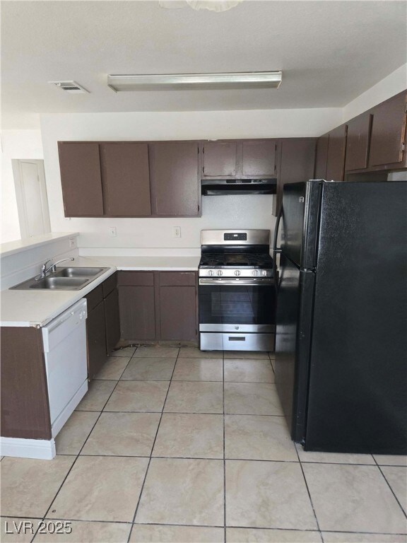 Kitchen featuring freestanding refrigerator, gas r