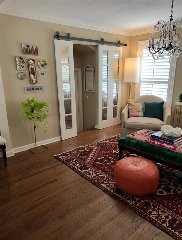 Living room featuring a barn door, a chandelier, c