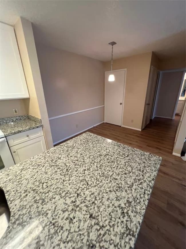 This photo showcases a kitchen area with granite c