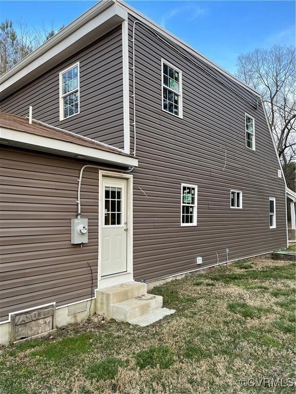 Rear view of house with a lawn