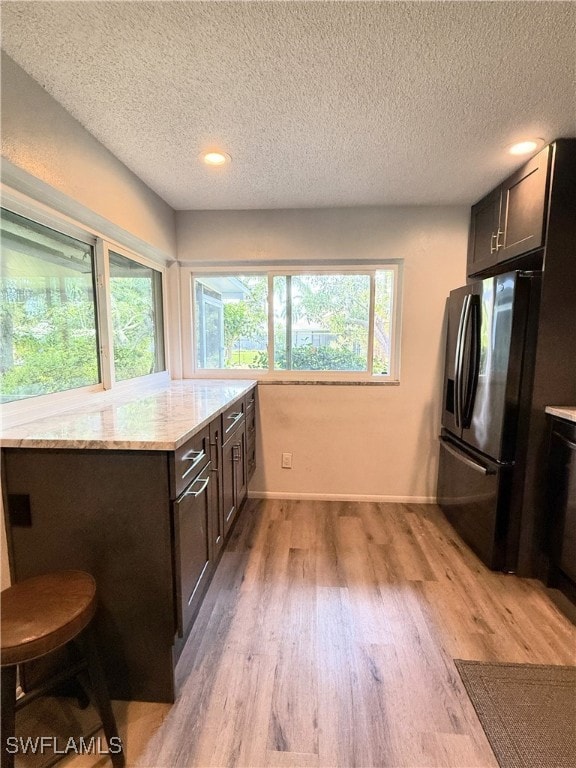 Kitchen featuring black refrigerator with ice disp