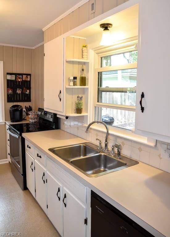 Kitchen sink with a window overlooking the backyar