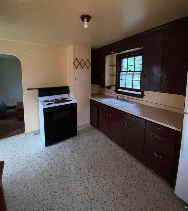 Kitchen featuring sink, white electric stove, and 