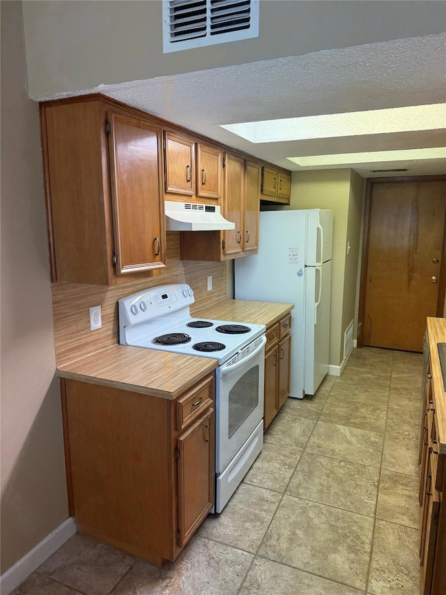 Galley kitchen with refrigerator