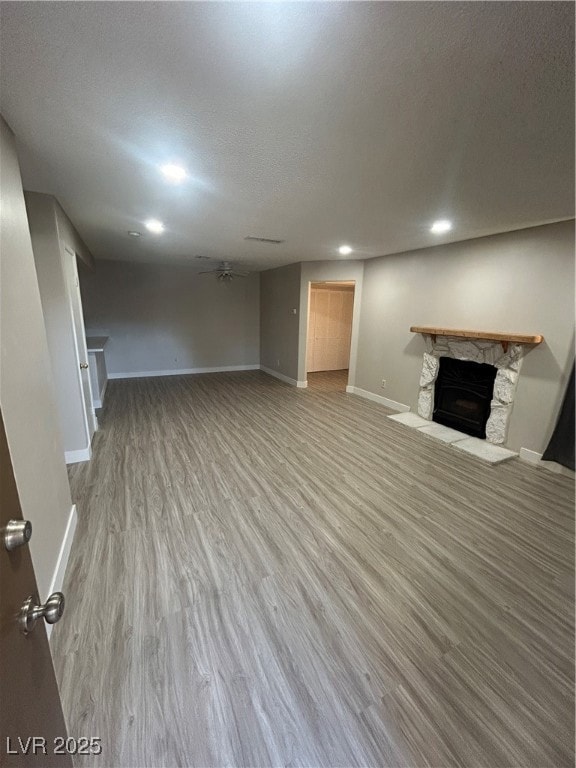 Unfurnished living room with a ceiling fan, a text
