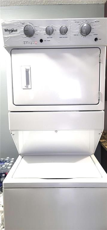 Unfurnished room with wood finished floors and a textured ceiling