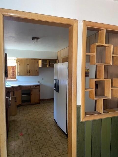 Kitchen featuring white fridge with ice dispenser