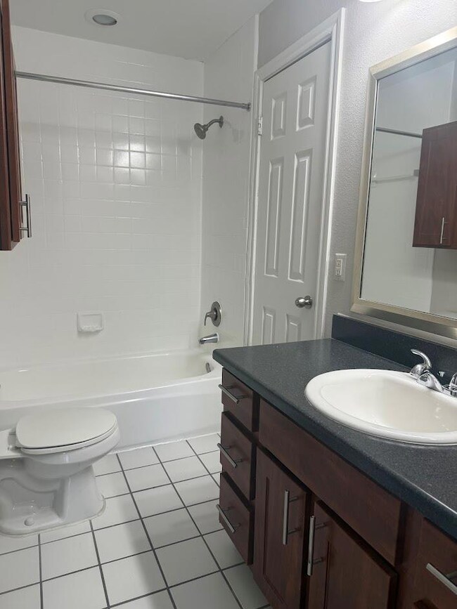 Bathroom with vanity, shower / bath combination, 