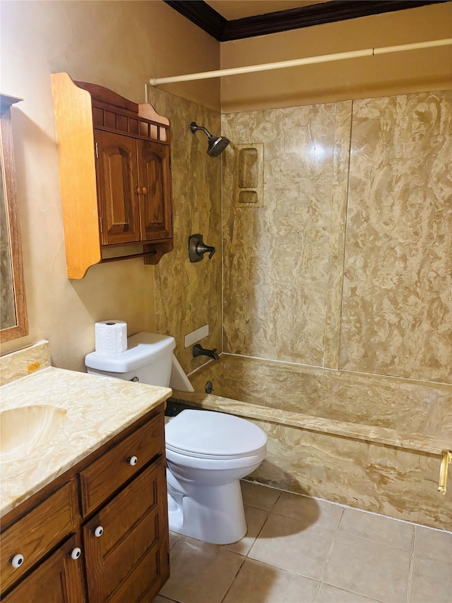Bathroom with vanity, light tile patterned floors, washtub / shower combination, and crown molding