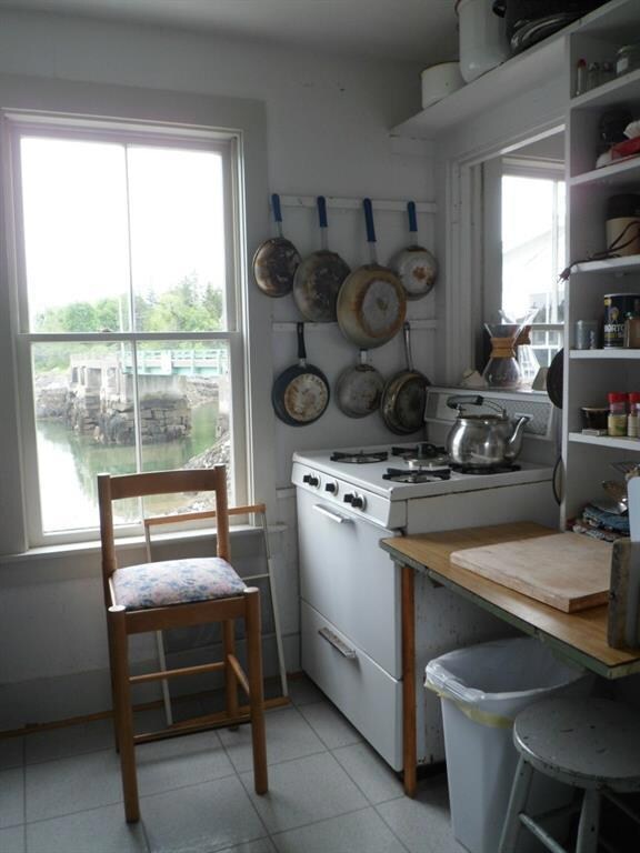 Cooking area of kitchen looks out...