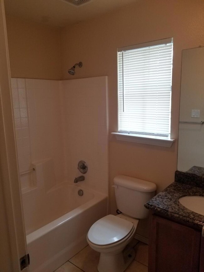 Full bathroom featuring vanity, tile patterned flo