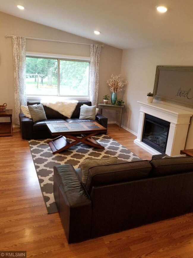 Bright open living area with vaulted ceiling and r